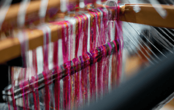 A loom weaving a fabric of wires, representing a data fabric